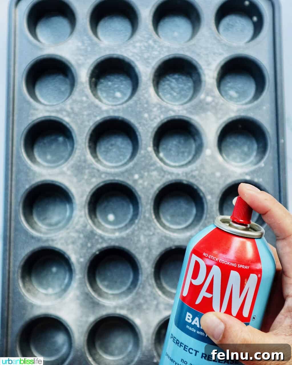 Spraying a muffin tin with cooking spray