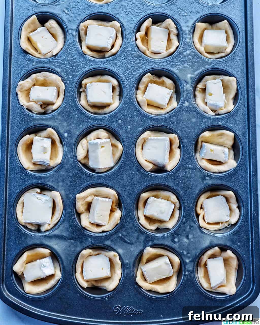 Cranberry brie tartlets in a muffin tin