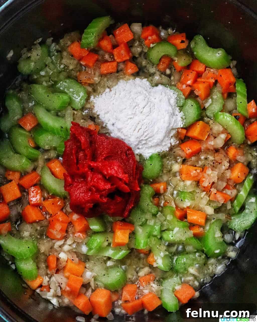 tomato paste and flour added to mirepoix of carrots, celery, and onions in a Dutch oven.