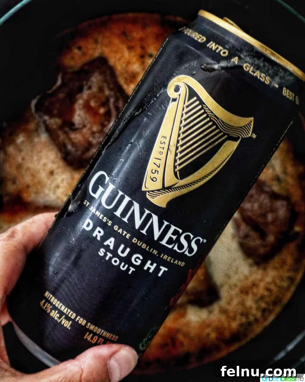 can of Guinness beer over beef short ribs in a Dutch oven.