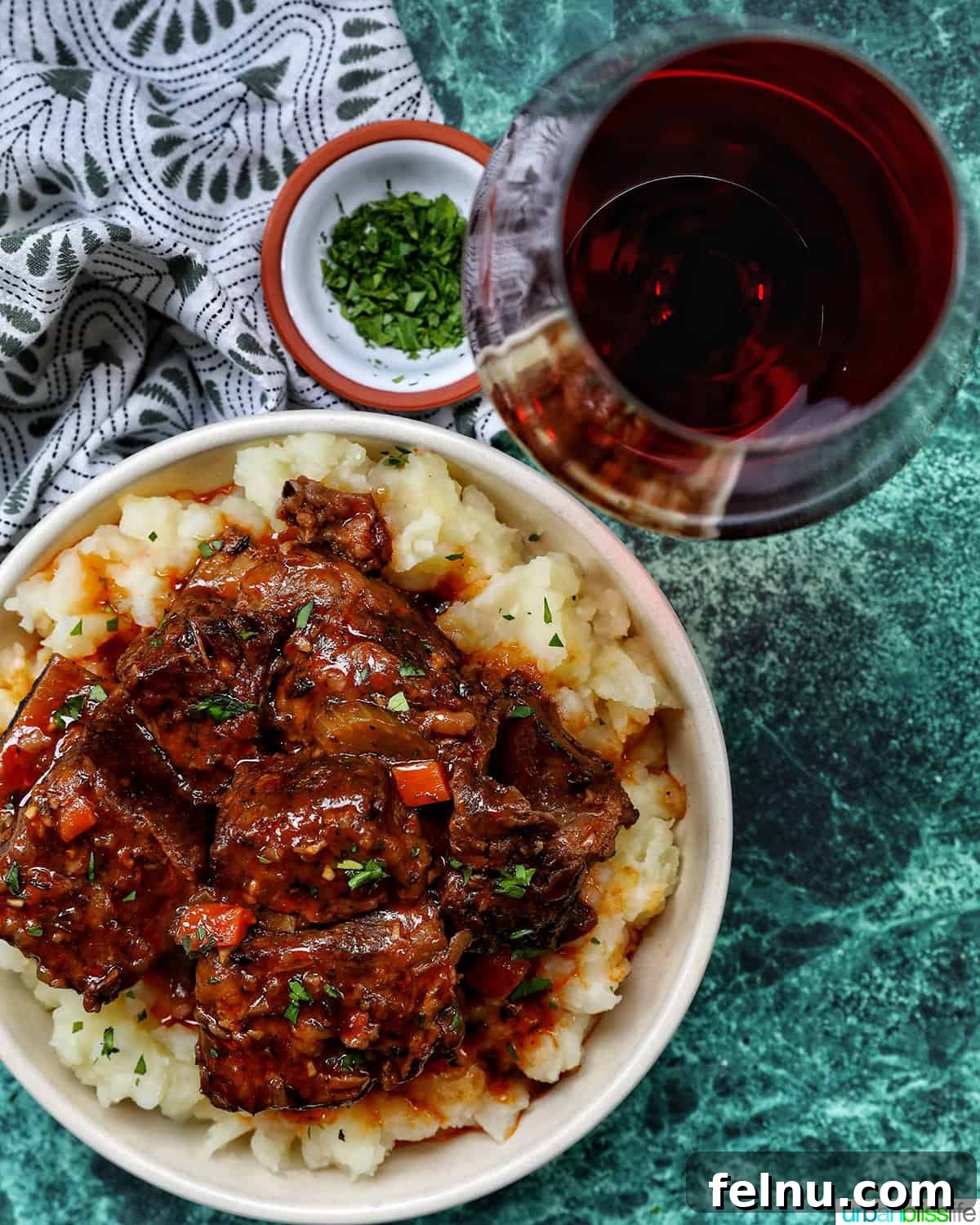beer braised short ribs over mashed potatoes and a glass of red wine.