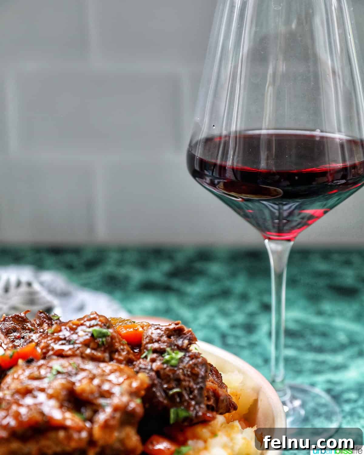 beer braised short ribs with glass of red wine.