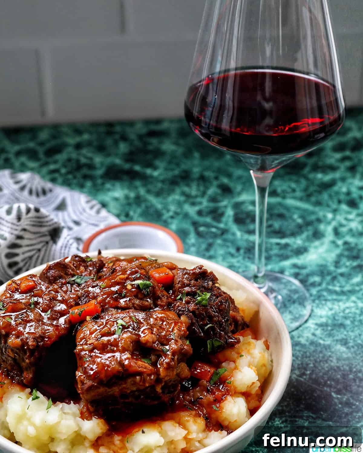 beer braised short ribs over mashed potatoes and a glass of red wine.