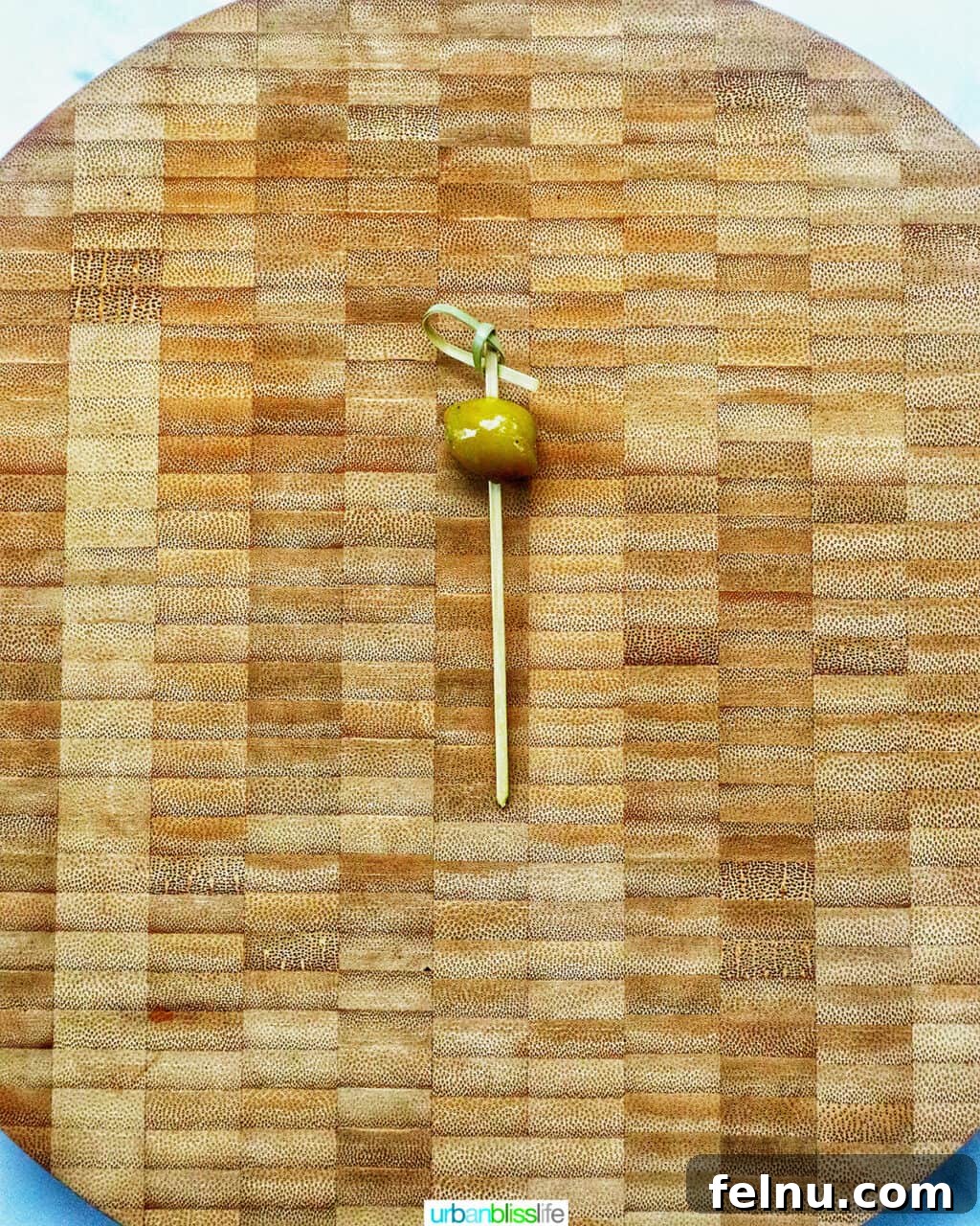 Antipasto Holiday Wreath 8 Food pick with an olive on a cutting board