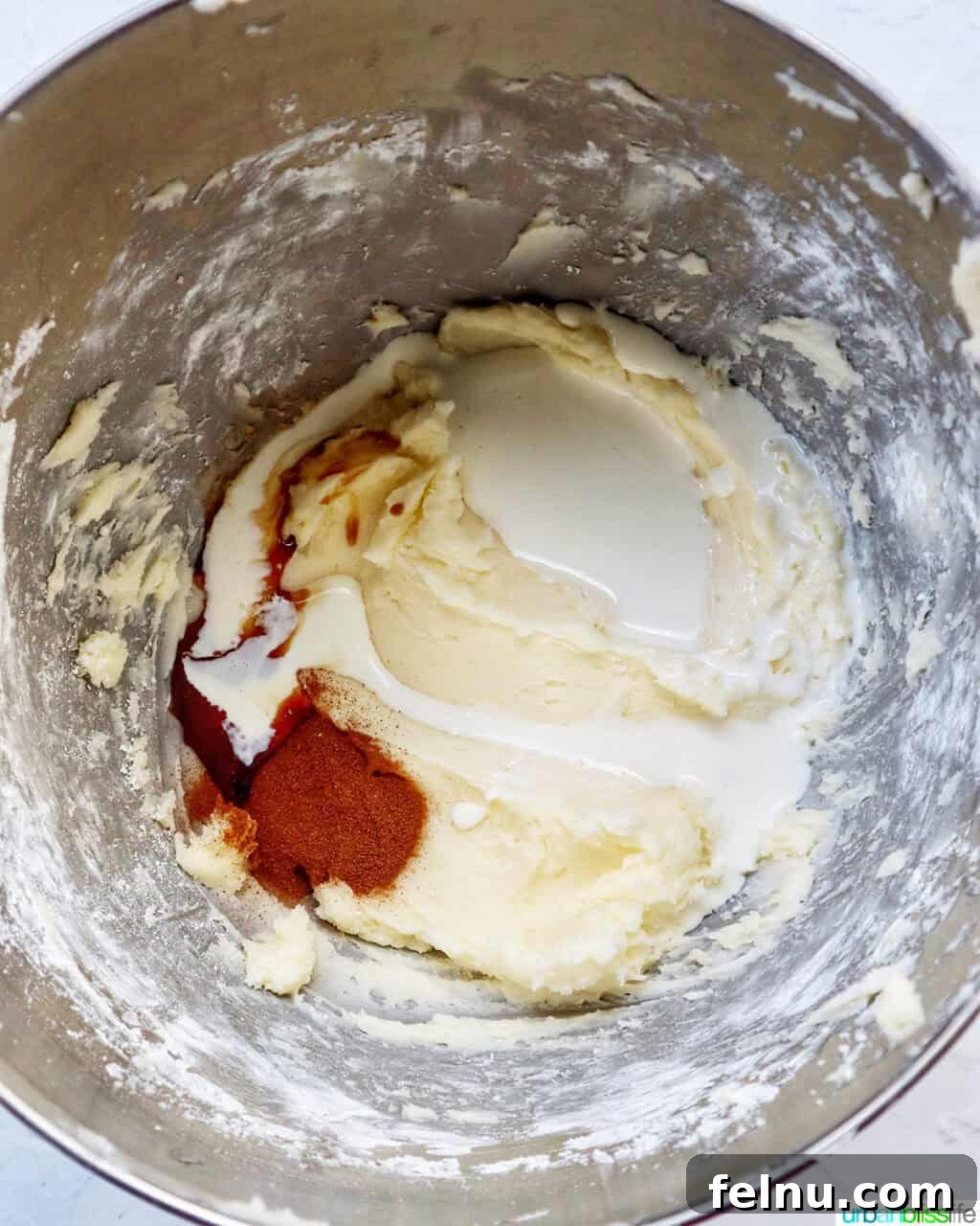 Cinnamon Swirl Delights 17 Ingredients in a stand mixer bowl to make frosting.
