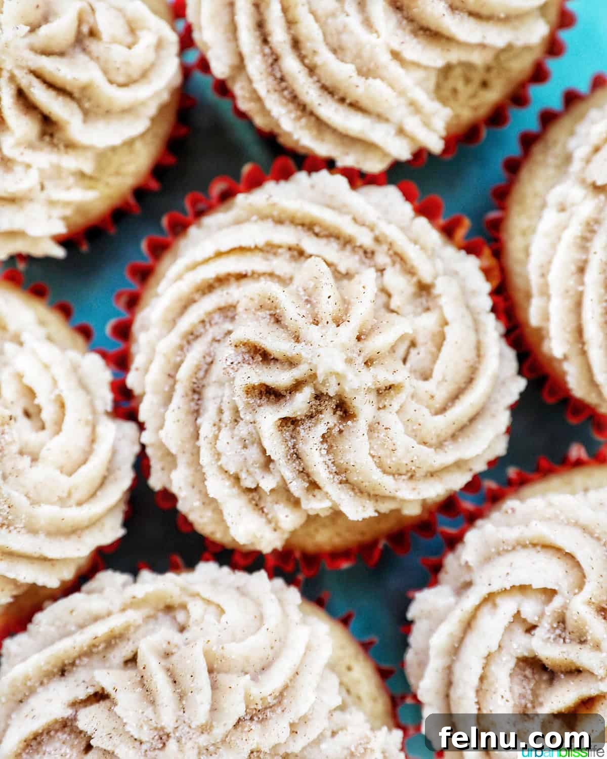 Cinnamon Swirl Delights 22 Overhead closeup view of cinnamon cupcakes on a blue cake pedestal.