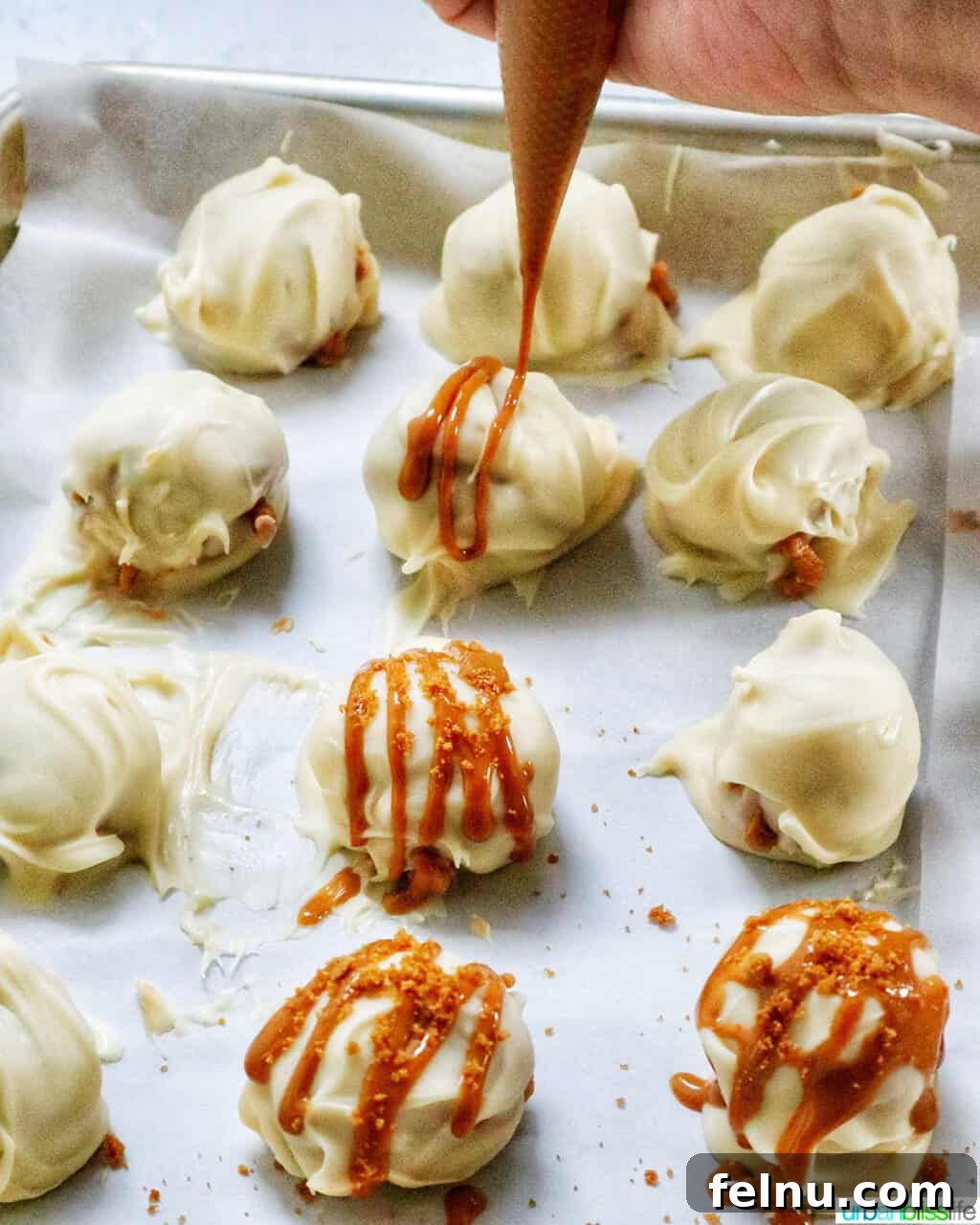 Biscoff Delights 13 Drizzling melted Biscoff cookie spread over white chocolate covered truffles.