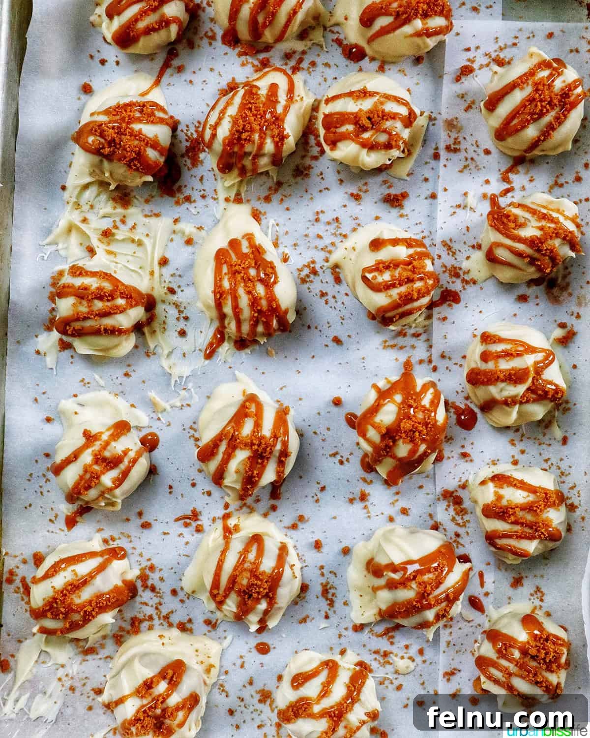 Biscoff Delights 14 Rows of beautifully decorated Biscoff truffles setting on a baking sheet.