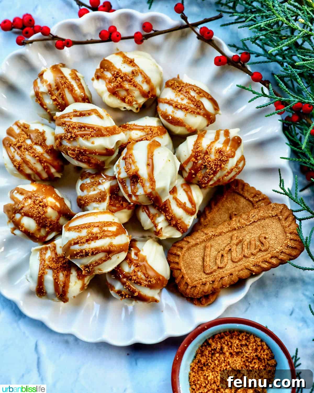 Biscoff Delights 15 Pile of Biscoff truffles on a plate, arranged with Biscoff cookies and festive holiday decorations.