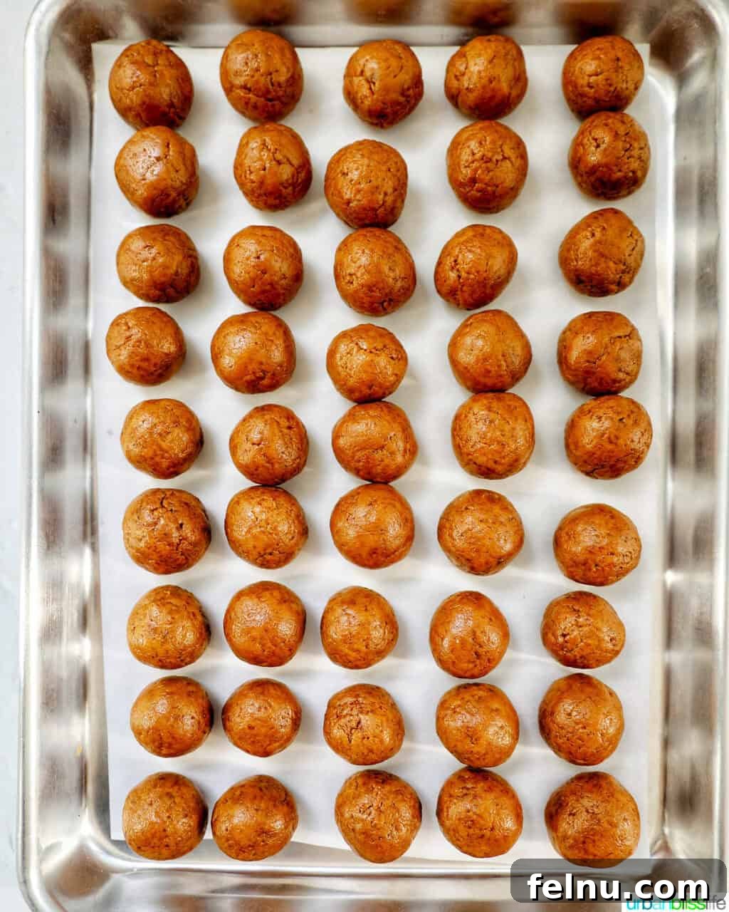 Biscoff Delights 10 Rows of small, evenly shaped Biscoff truffles on a baking sheet.