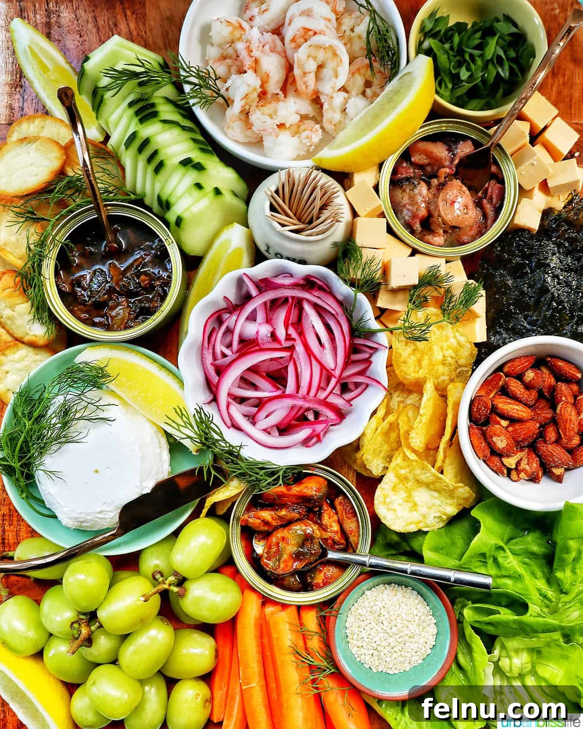 Elevate Your Oysters The Perfect Wine Pairings 4 A beautifully arranged seacuterie board featuring tinned fish, fresh fruits, vegetables, chips, crackers, and elegant garnishes.