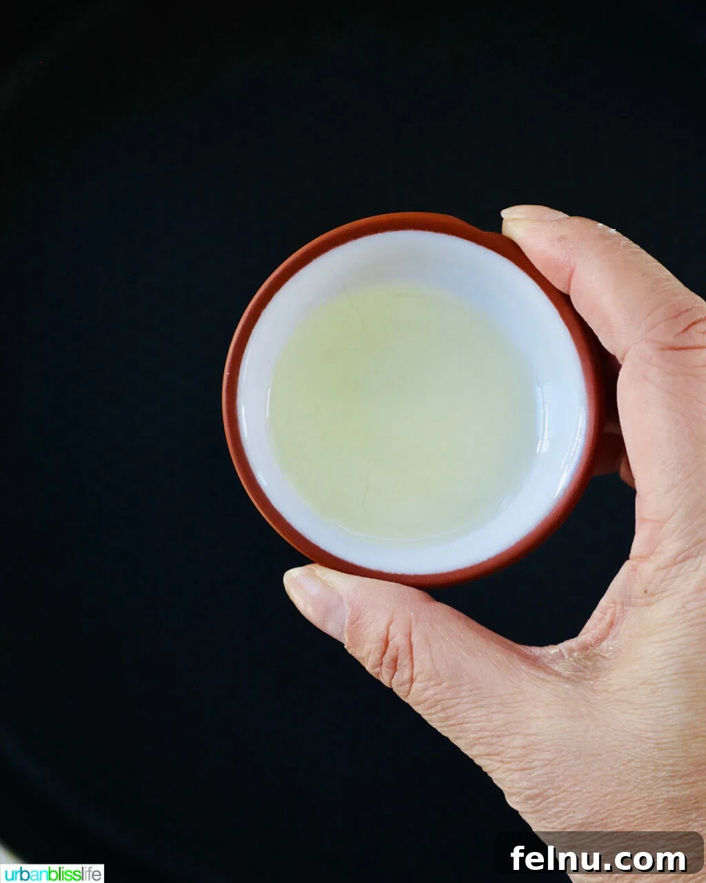 Adding oil to a pan.
