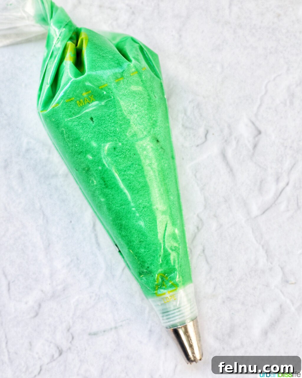 Touchdown Treats 11 Green buttercream frosting in a piping bag with a grass tip.