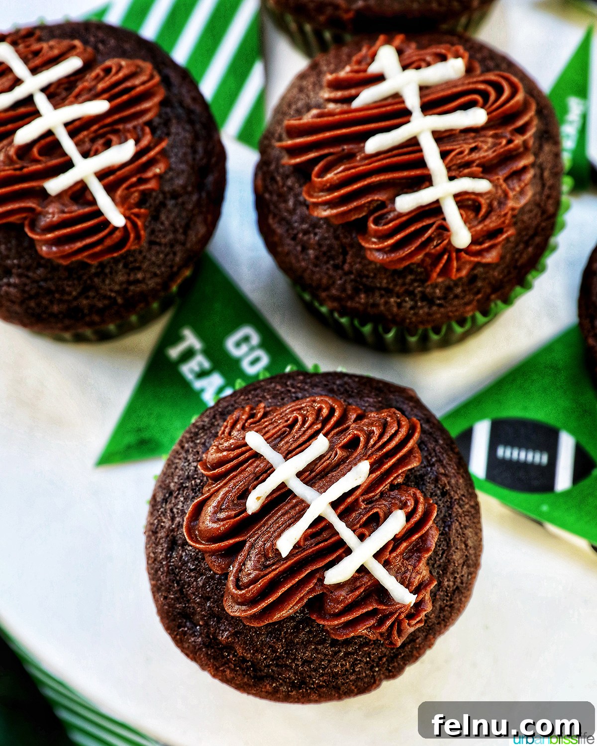 Touchdown Treats 16 Close-up of football cupcakes without the green grass decorations, showing the chocolate football and white laces.