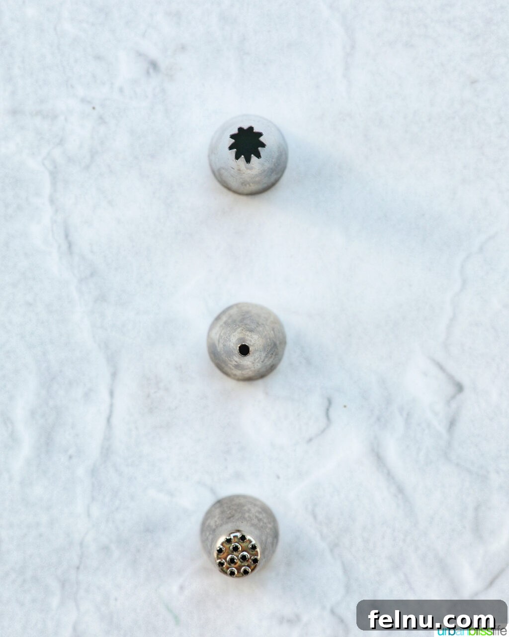 Touchdown Treats 18 Three different piping tips commonly used for baking and decorating, including a star tip, a round tip, and a grass tip.