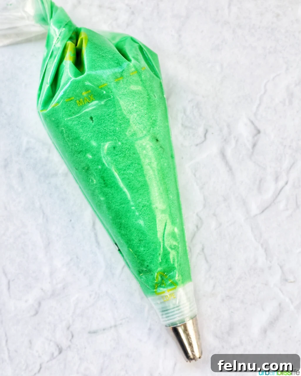 Touchdown Treats 19 Green frosting in a piping bag with a grass tip, ready for use.