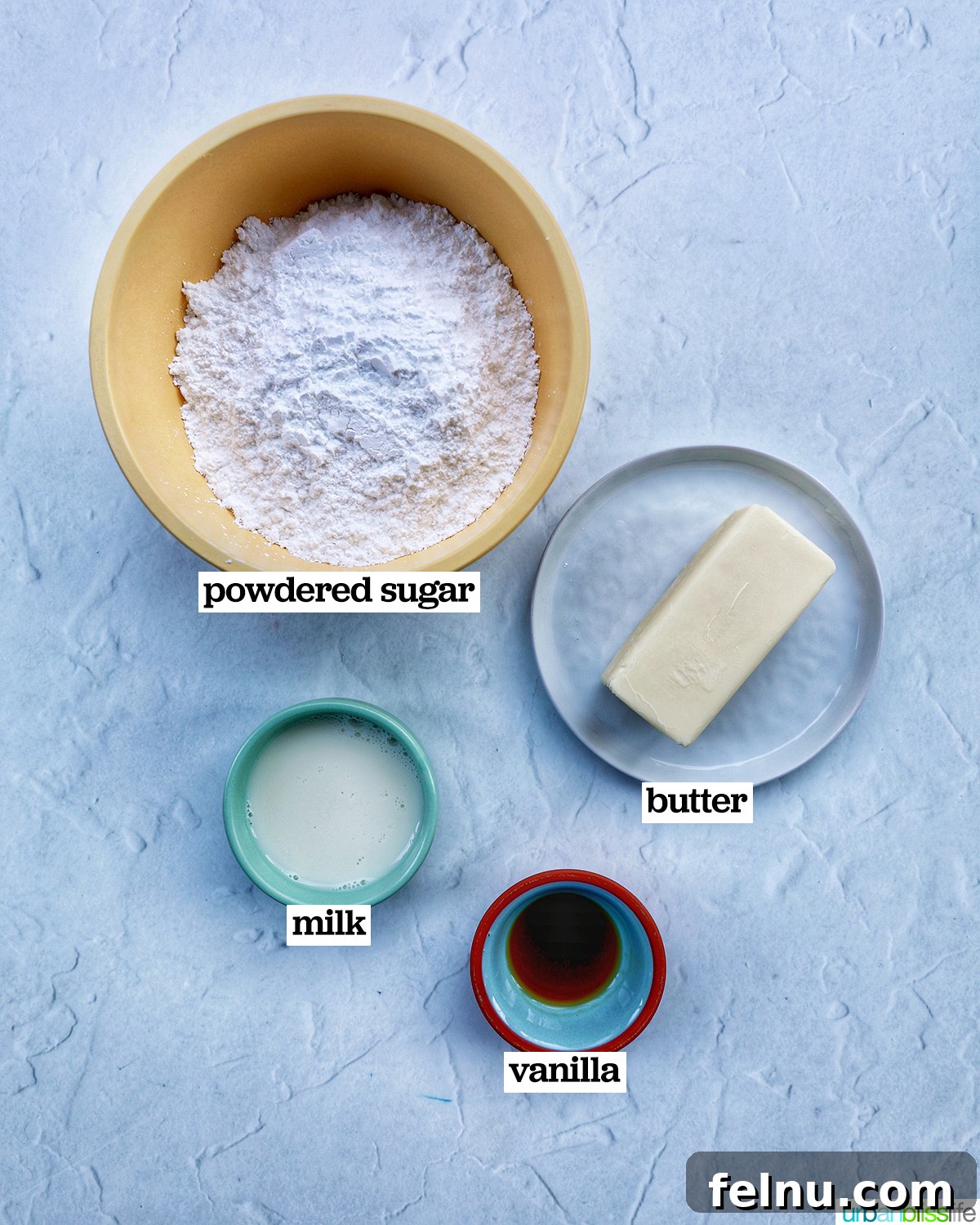 Touchdown Treats 5 Ingredients laid out for making vanilla buttercream frosting, including butter, powdered sugar, milk, and vanilla extract.