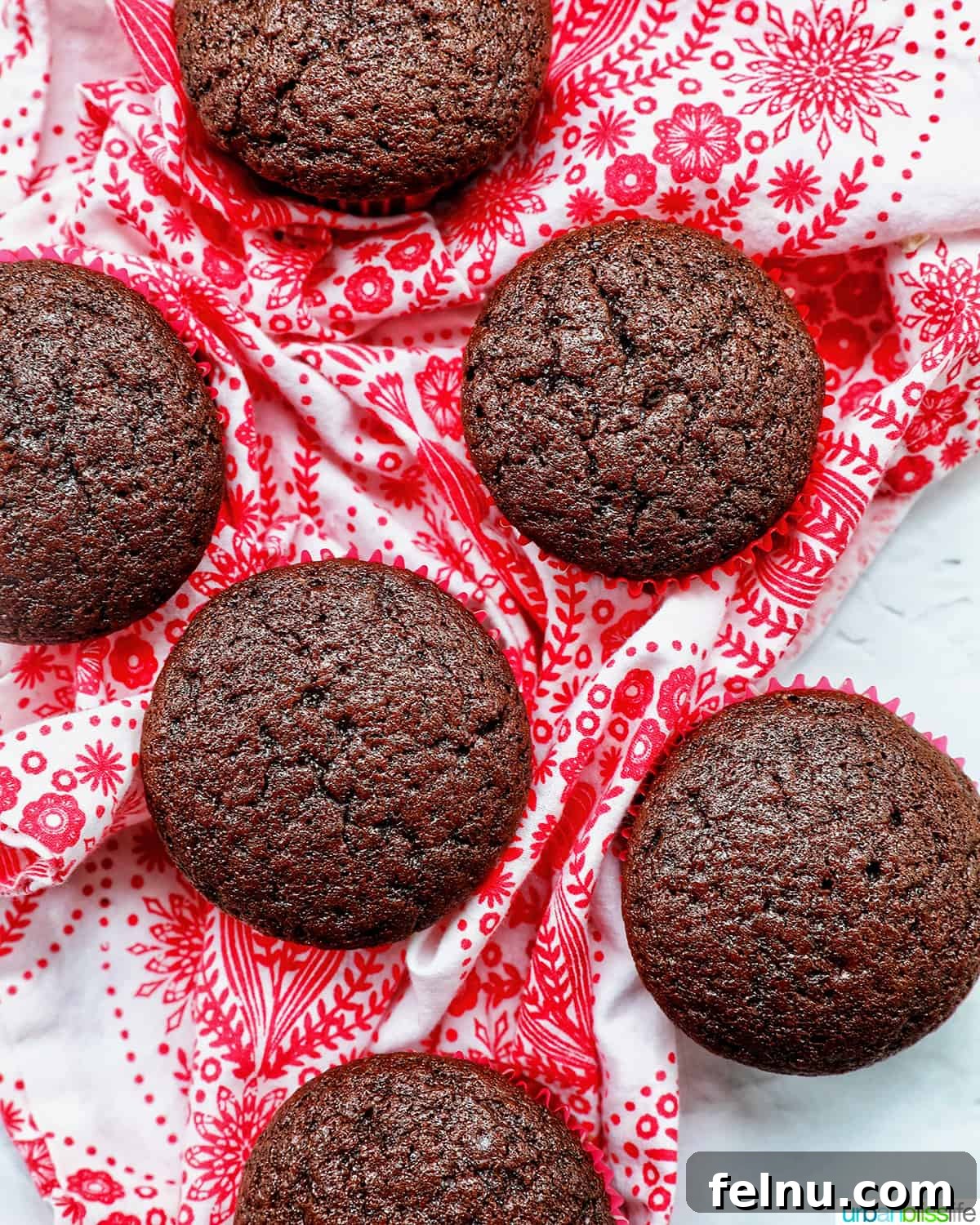 Touchdown Treats 6 Stack of chocolate cupcakes without frosting on a red and white napkin, cooling.