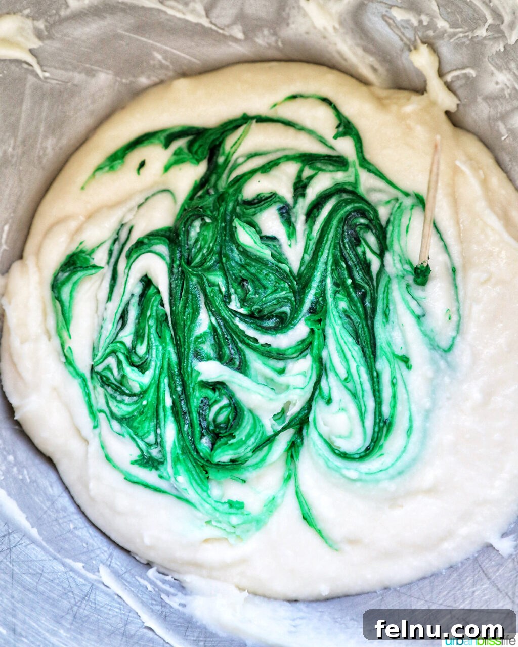 Touchdown Treats 9 Vanilla buttercream frosting with green food coloring added, being stirred to create the grass effect.