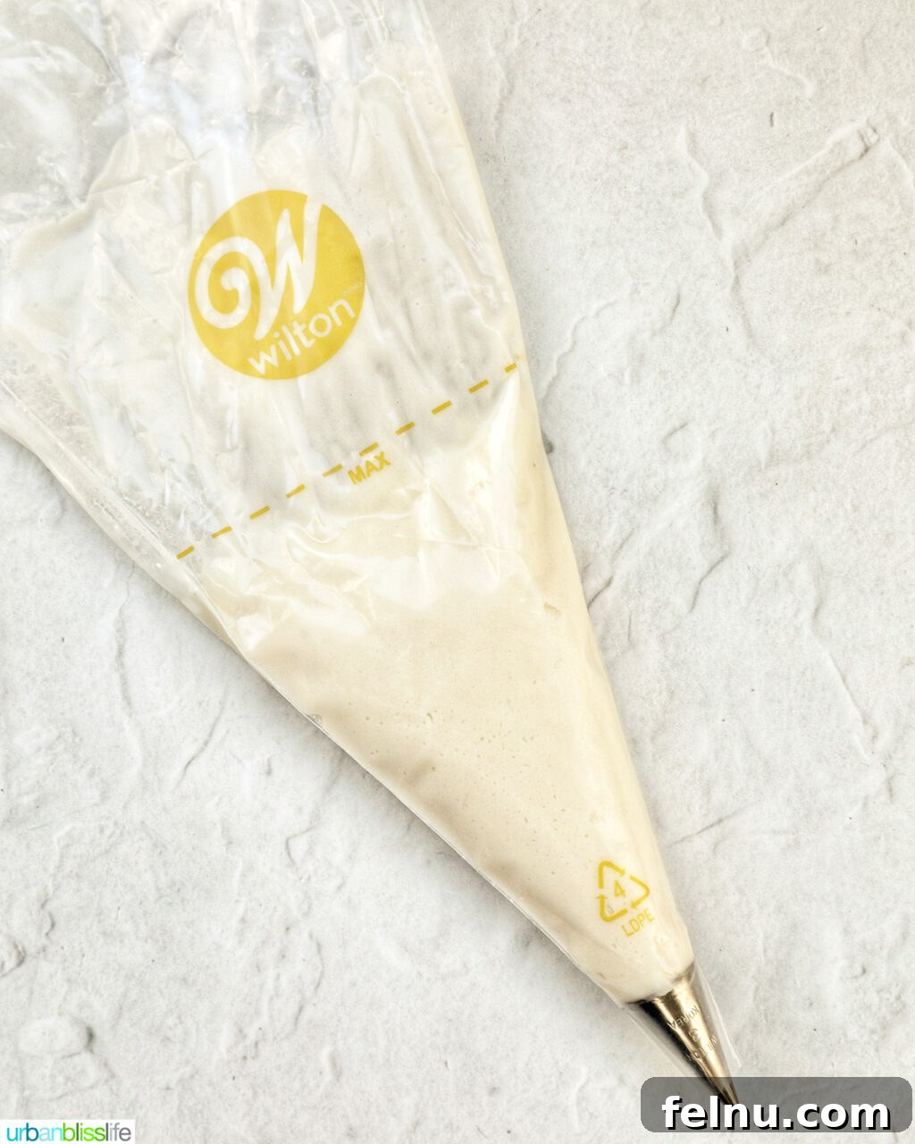 Touchdown Treats 10 White vanilla buttercream frosting in a piping bag with a small round tip.