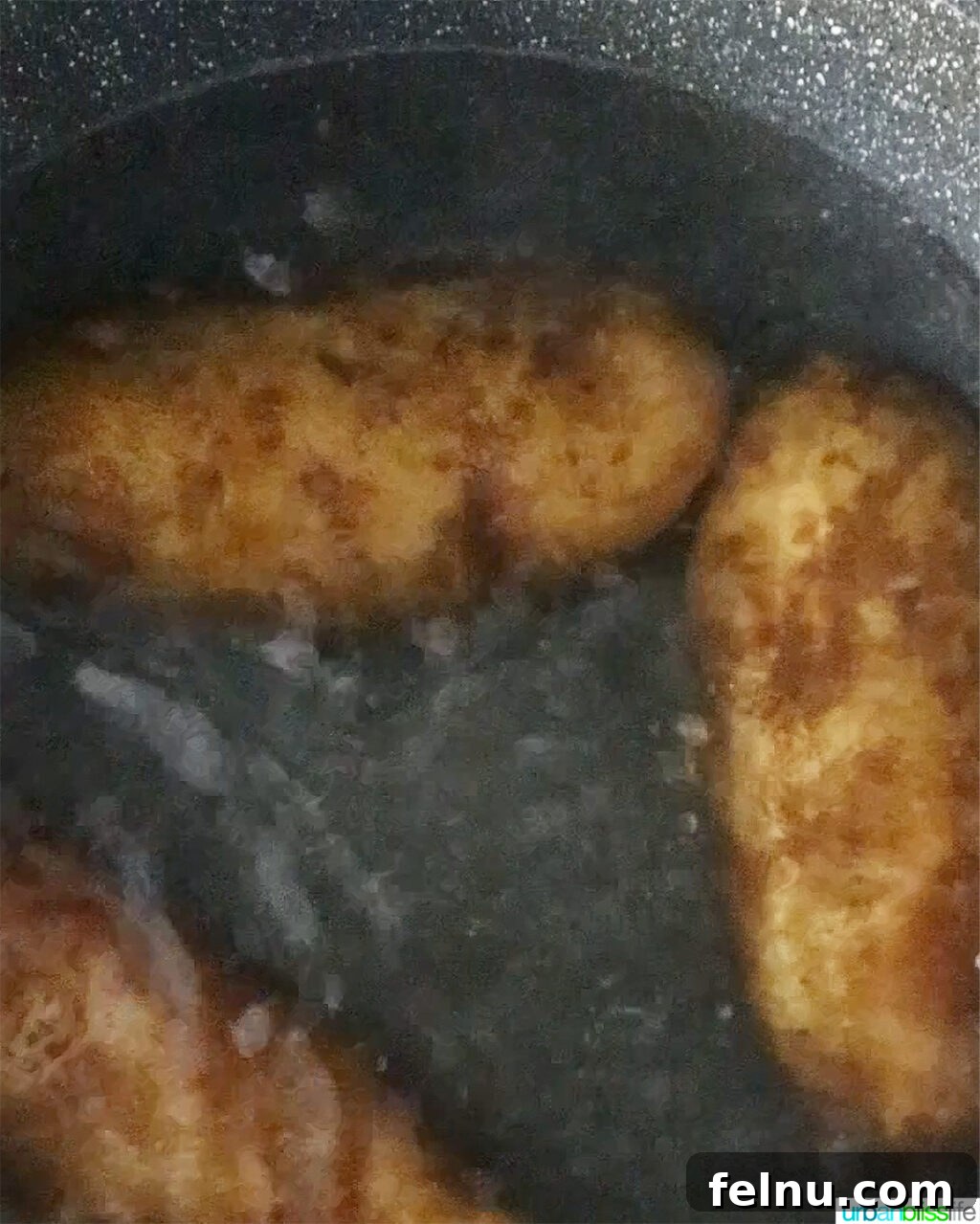 Hearty Spud Indulgence 5 Russet potatoes boiling in a large pot of water on the stove.