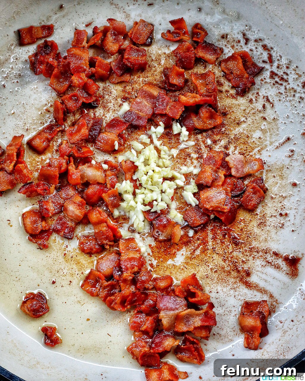 Bacon Pesto Pasta Delight 8 Adding garlic to bacon in pan