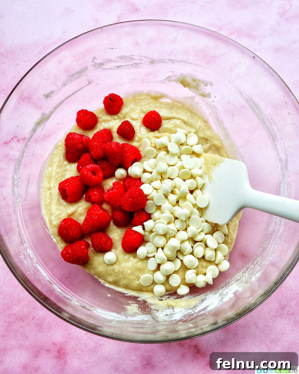 raspberries and white chocolate chips in a bowl.