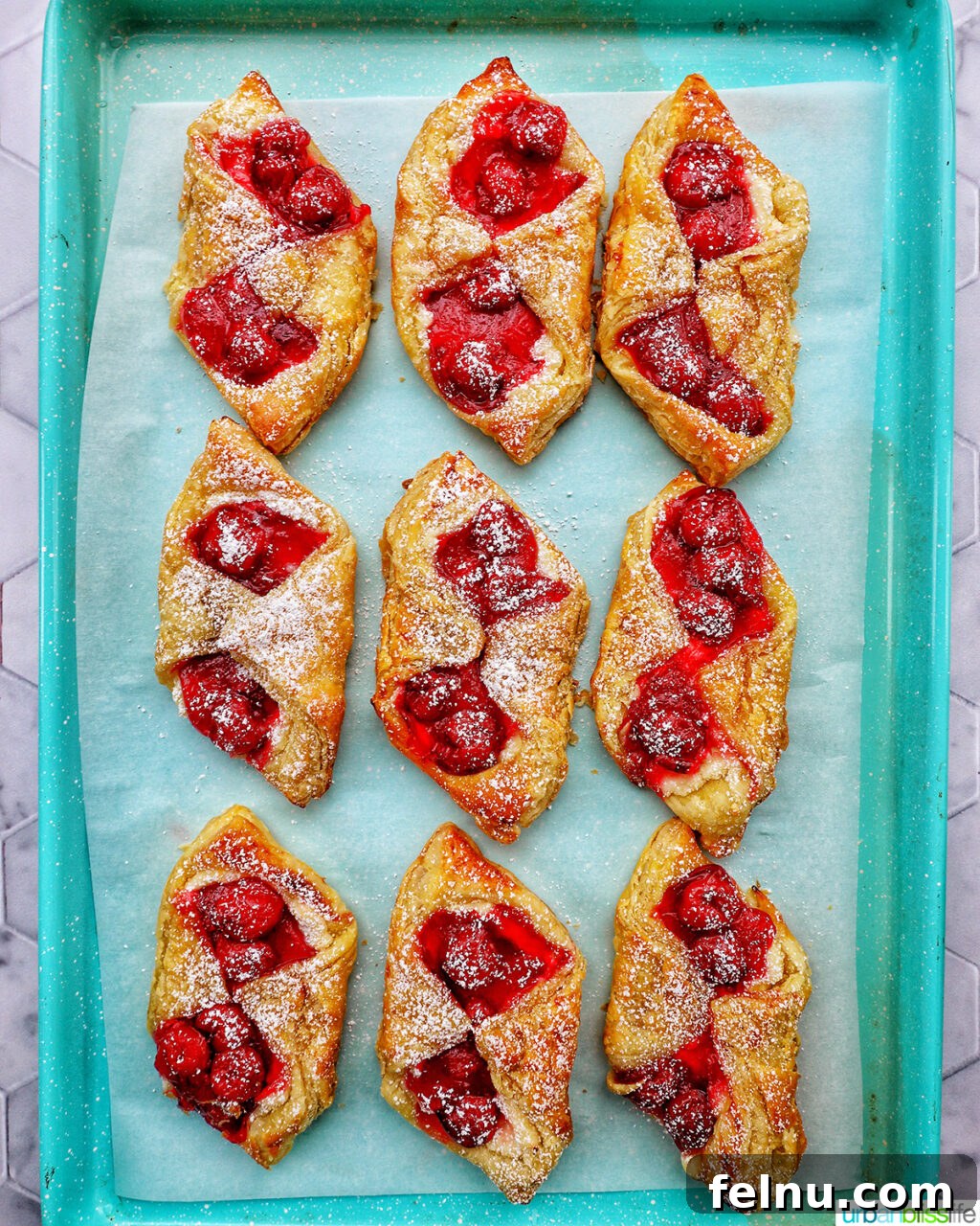 Cherry danishes on a baking sheet