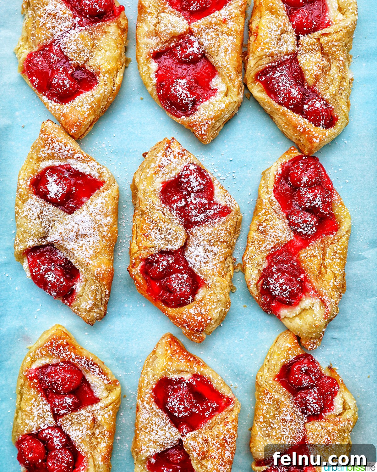 Cherry Delight Pastry 16 Cherry Danish pastries on a baking sheet