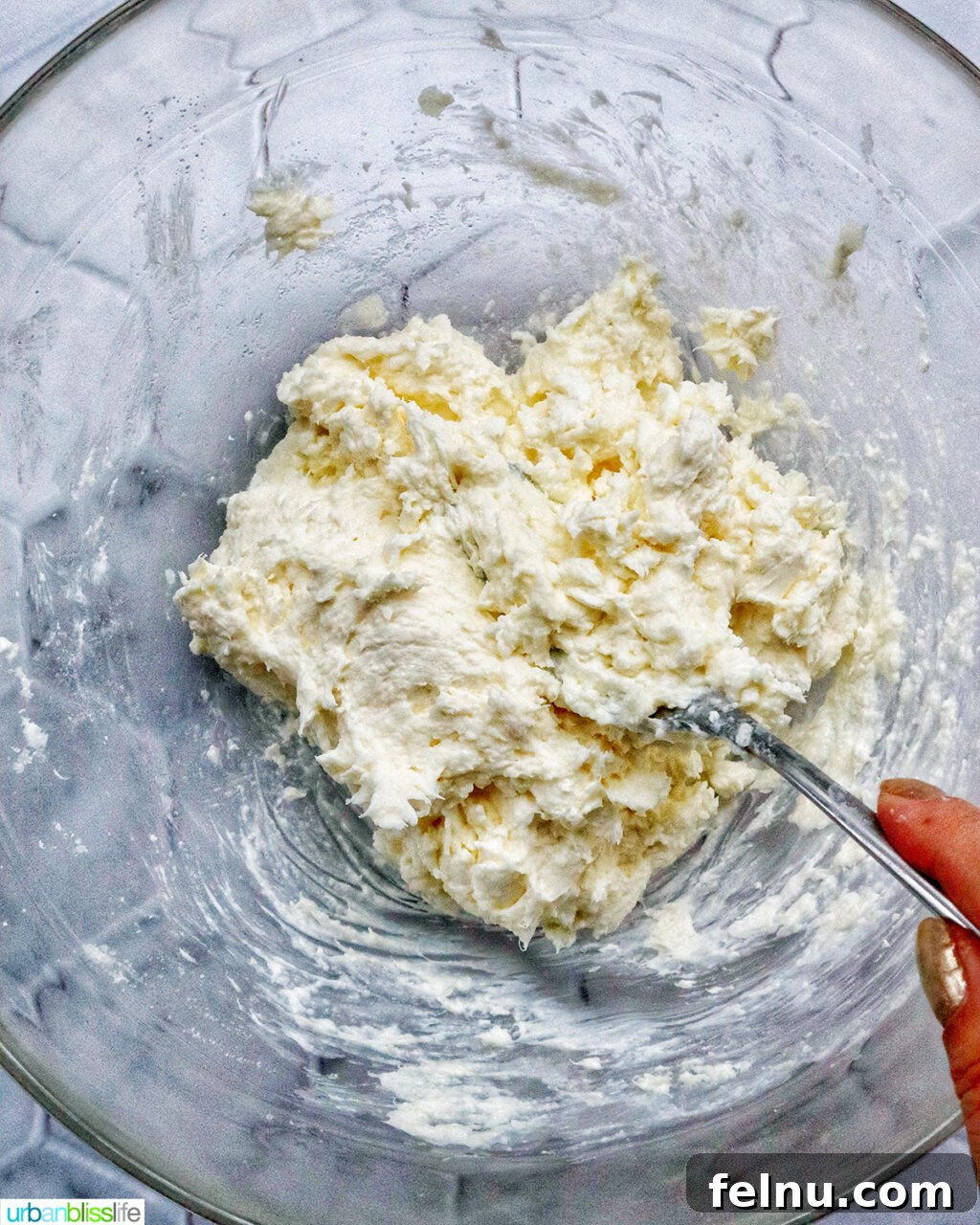 Mixing a cream cheese mixture in a bowl
