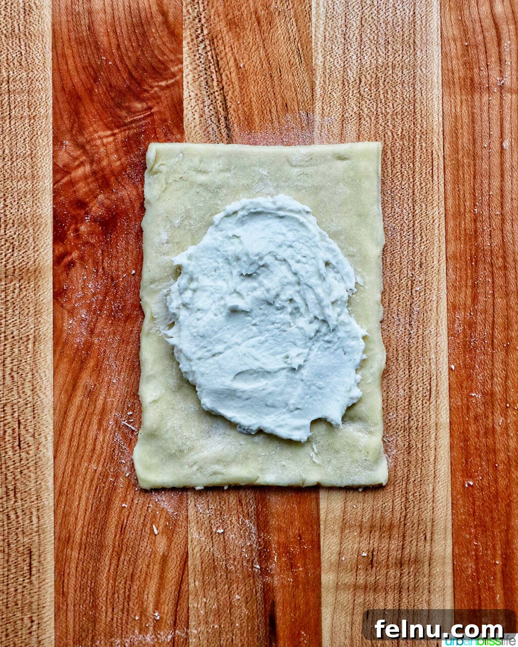 Cream cheese and puff pastry on a cutting board