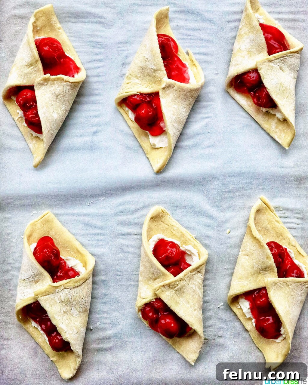 Cherry danishes on a baking sheet
