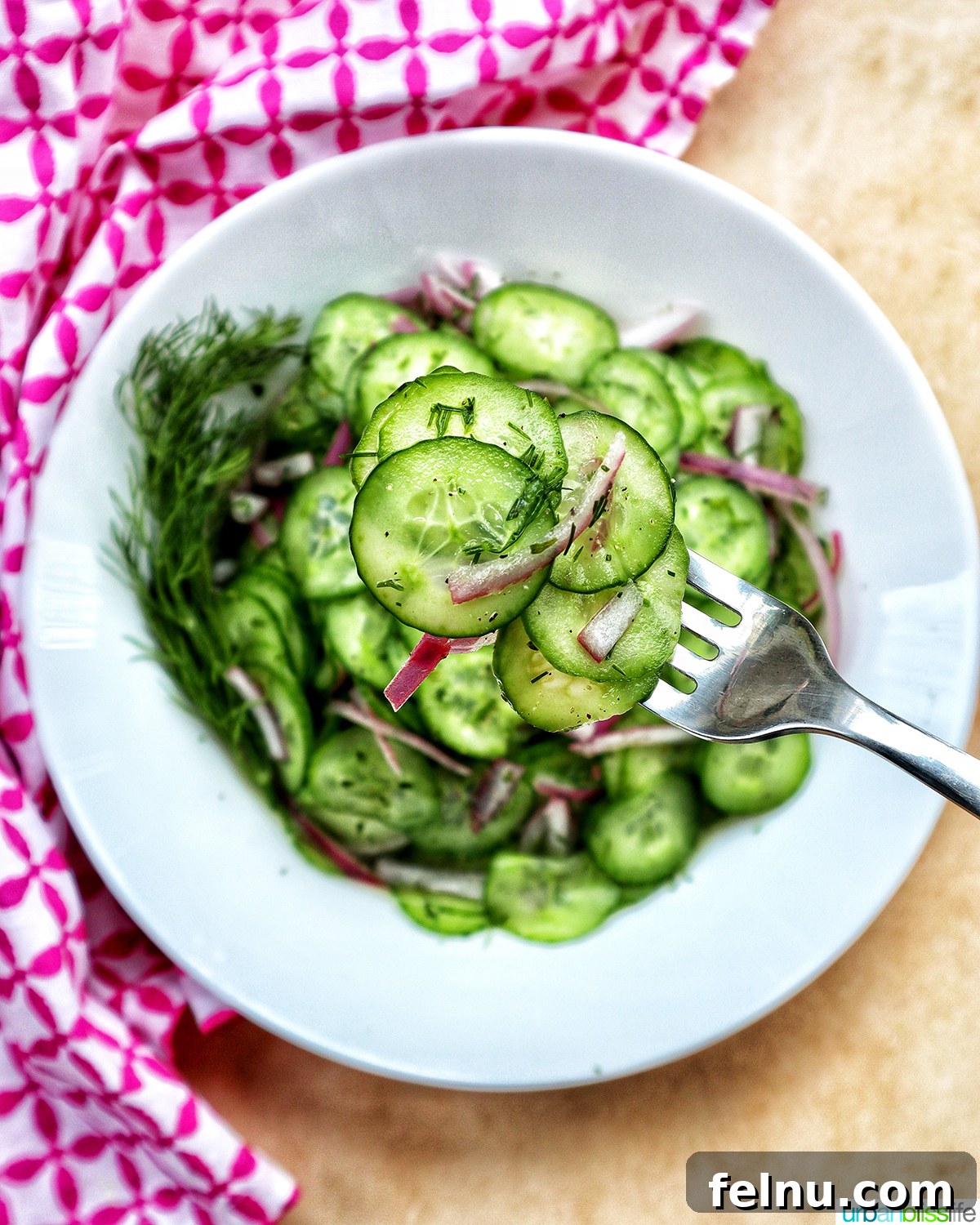 Garden Fresh Cucumber Dill Salad 8 bowl of cucumber dill salad with forkful of salad.