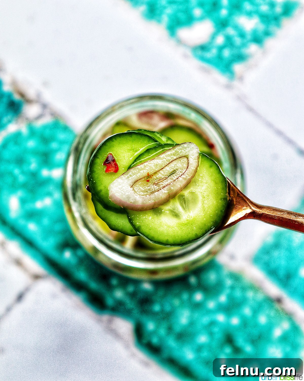 Spicy Asian Cucumber Pickles 9 forkful of pickled cucumbers over a jar of Asian pickled cucumbers.