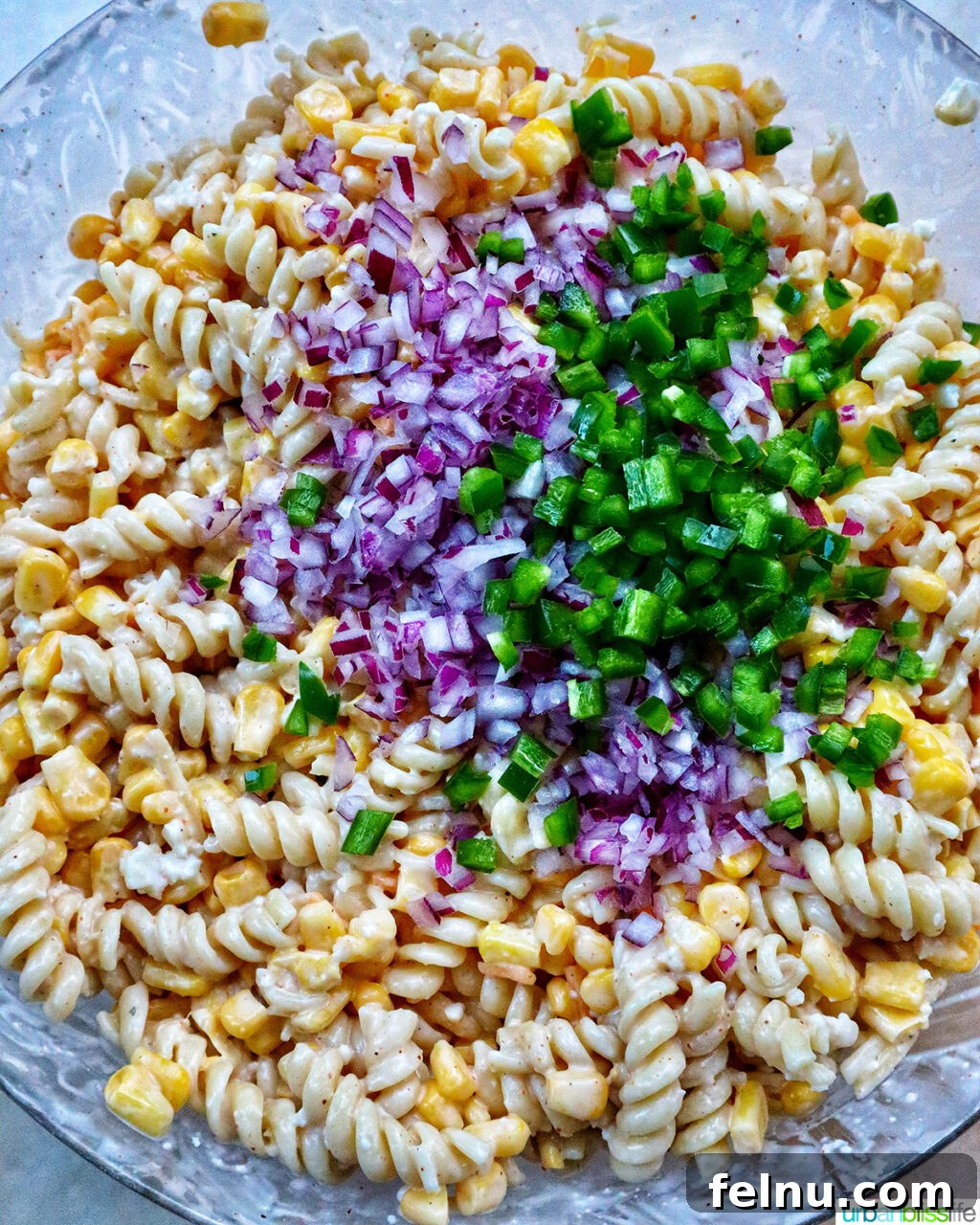 Zesty Elote Pasta Salad 14 The fully assembled Mexican street corn pasta salad, vibrant and enticing, ready for its final chill before serving.