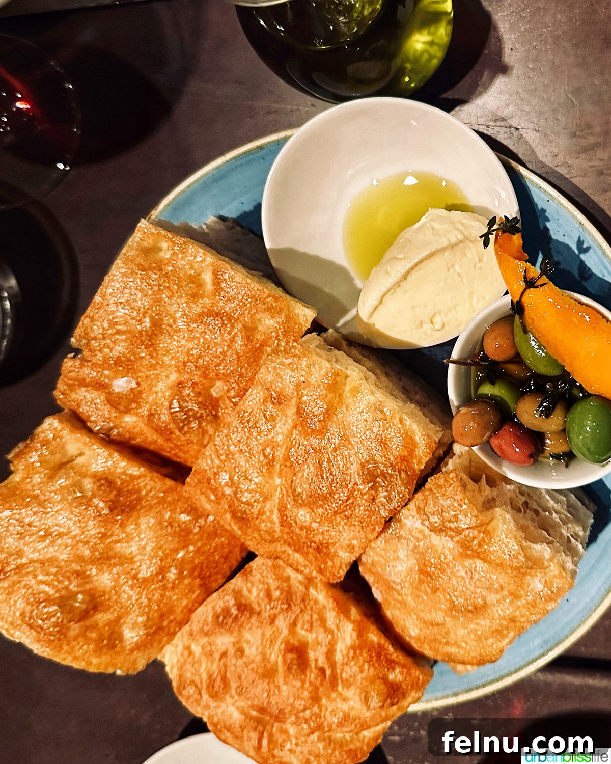 Carlotto's New York Slice 6 House-made focaccia bread and marinated olives at Carlotto restaurant in NYC.
