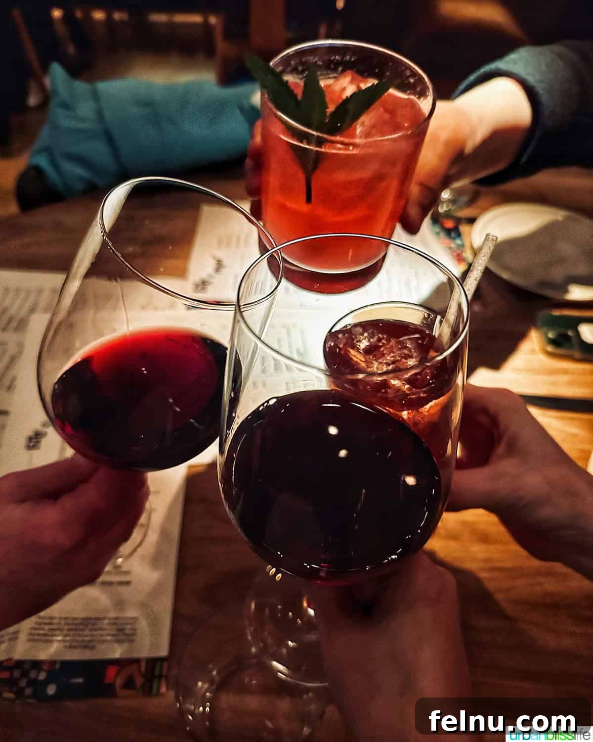 Hav and Mar Restaurant New York City 12 cheers with glasses of wine and cocktails.