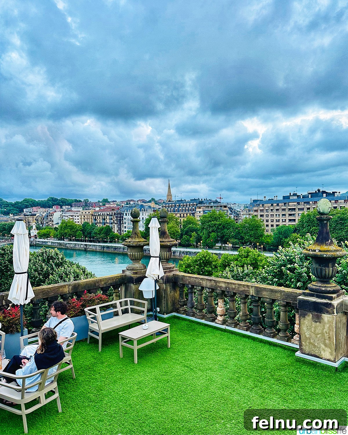 Panoramic view of San Sebastian from the Abba Hotel rooftop, showcasing the city's charming architecture and urban landscape with the river snaking through.
