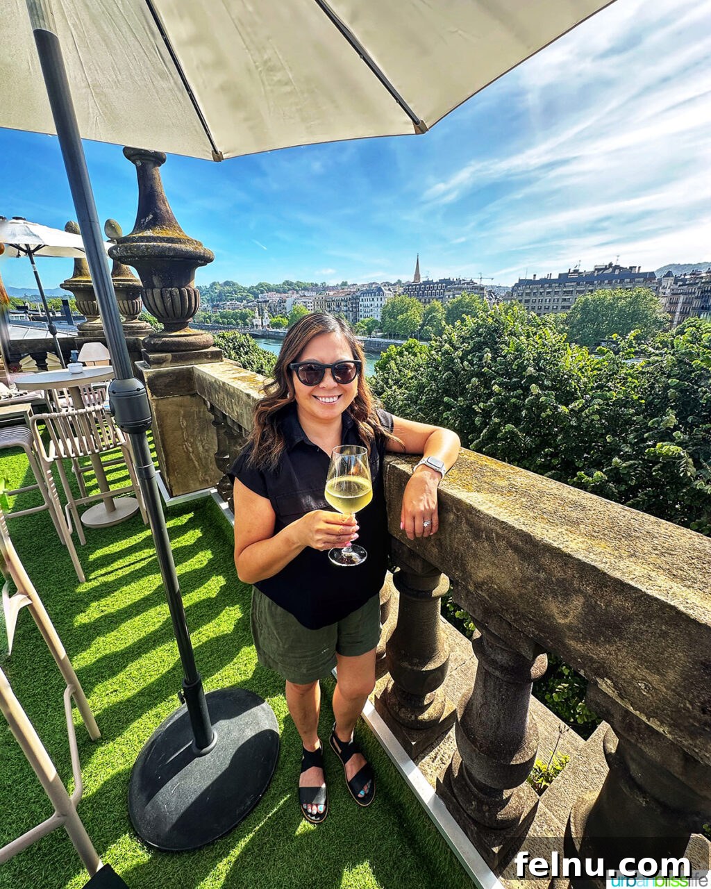 Marlynn enjoying a drink on the stylish rooftop bar at Hotel Abba San Sebastian, overlooking the picturesque city.