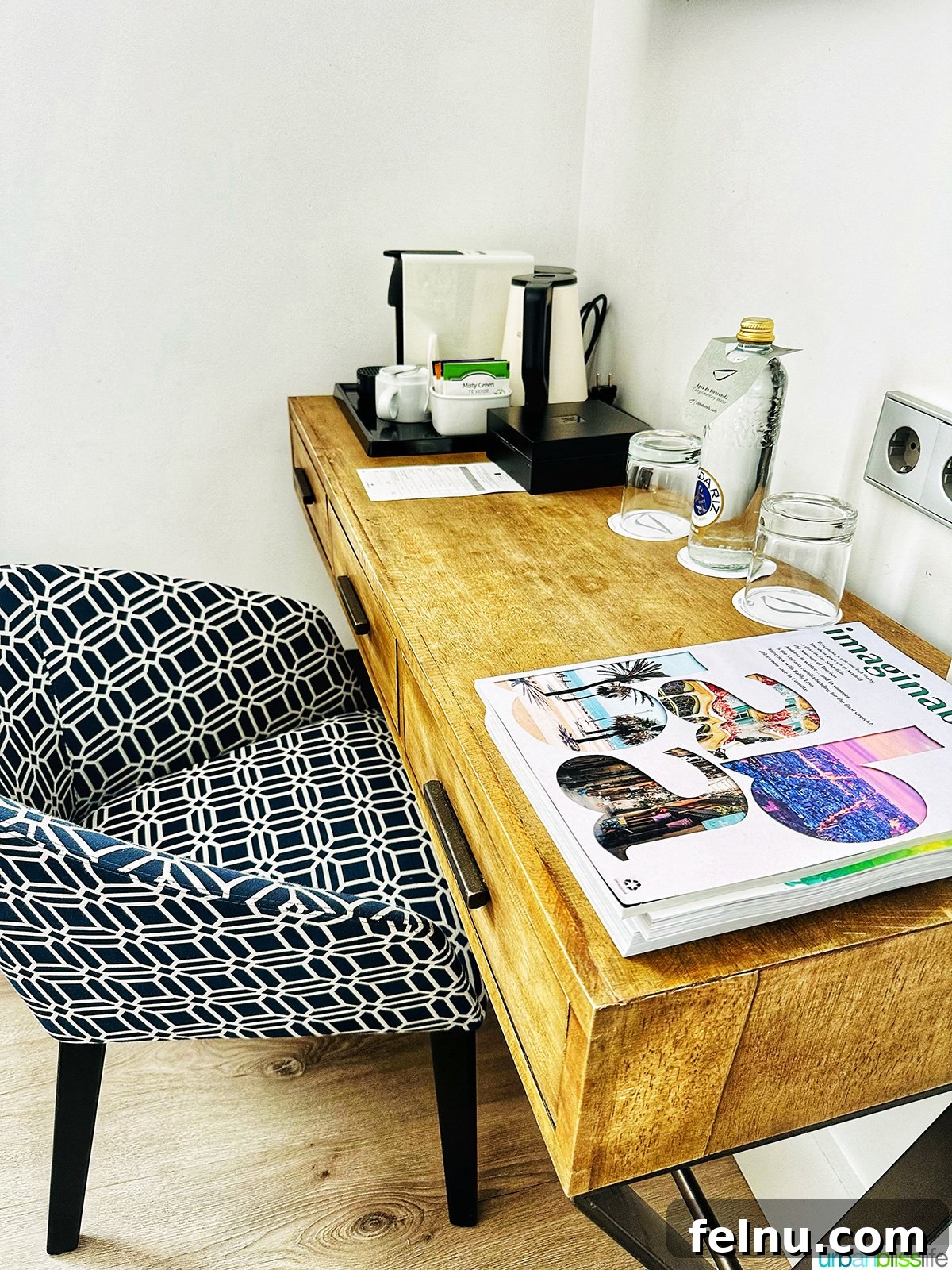 A well-lit desk area with a chair in a deluxe corner room at Hotel Abba San Sebastian, perfect for work or planning.
