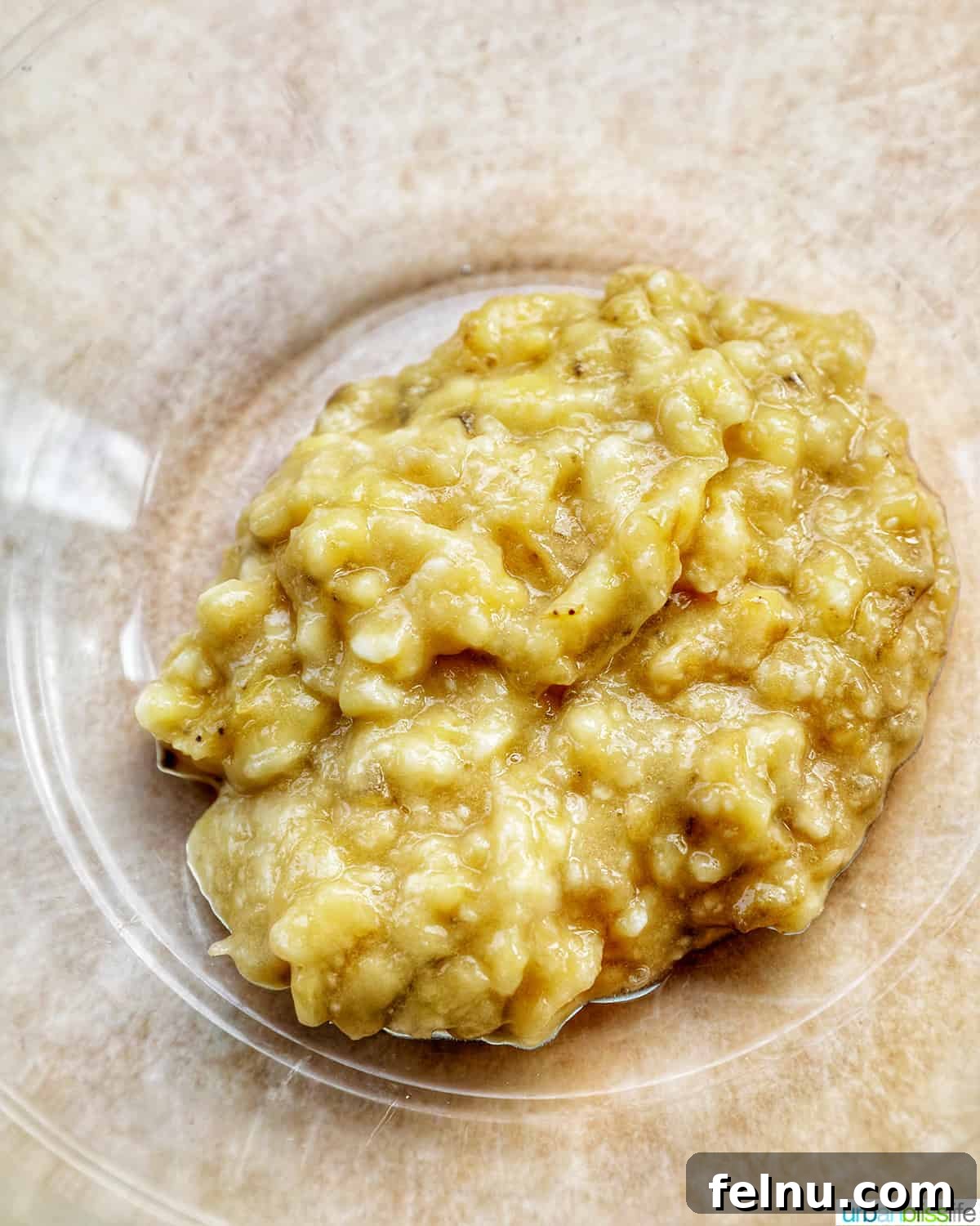 Seamless Swaps: Egg Substitutes for Every Dish 7 Perfectly mashed bananas in a bowl, ready to be incorporated into a recipe as an egg substitute.
