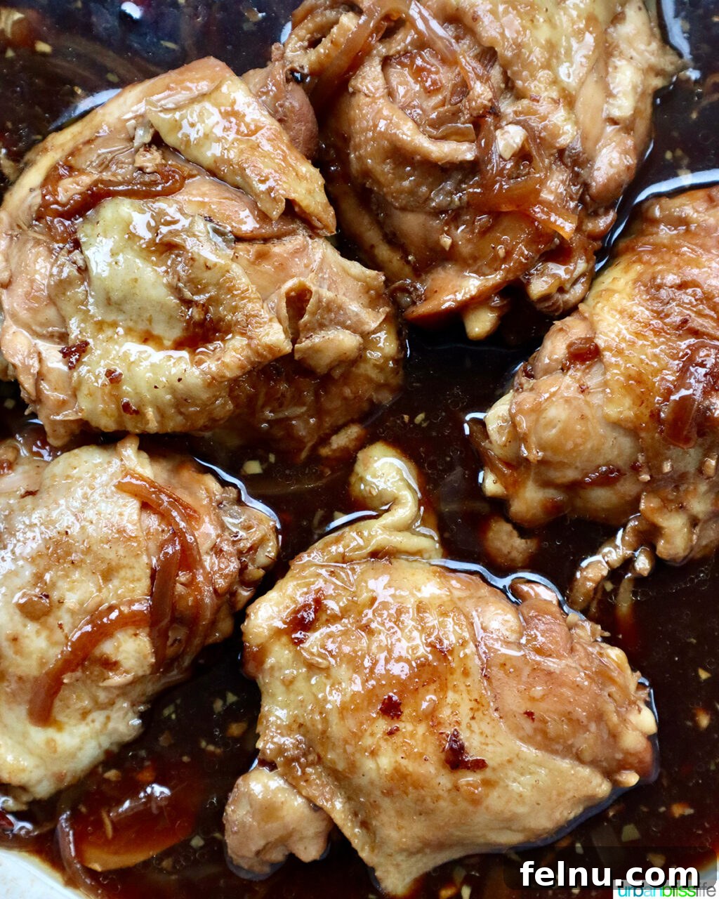 Fragrant Chinese Braised Chicken 14 Chinese braised chicken thighs simmering in a covered skillet.