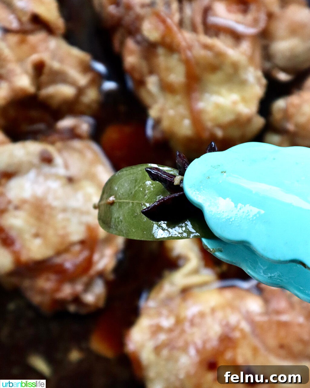 Fragrant Chinese Braised Chicken 15 Lid being removed from the skillet, revealing cooked Chinese Braised Chicken.