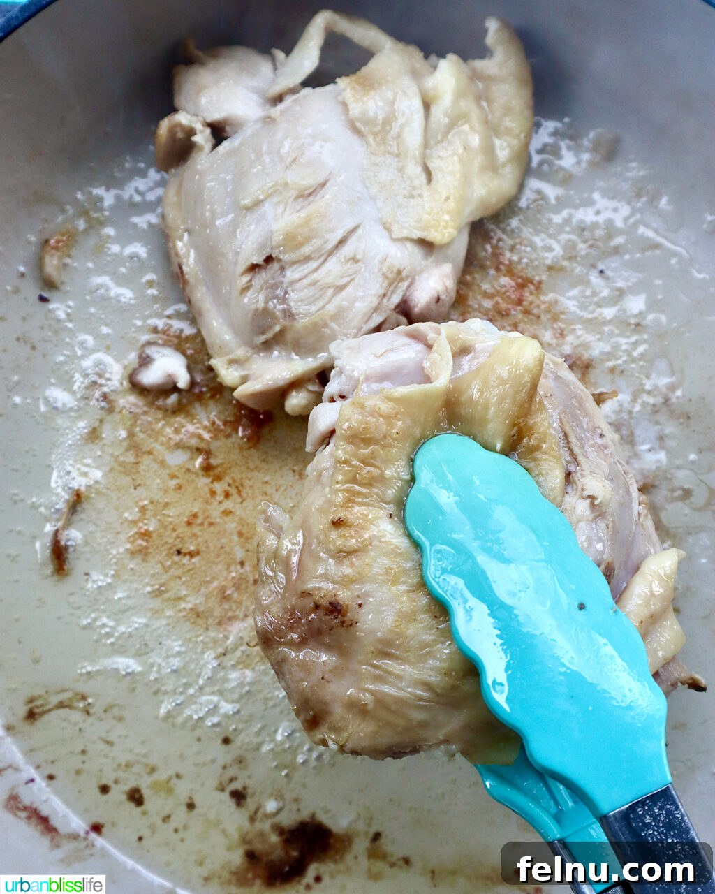 Fragrant Chinese Braised Chicken 7 Tongs flipping chicken thighs to brown evenly in a skillet.