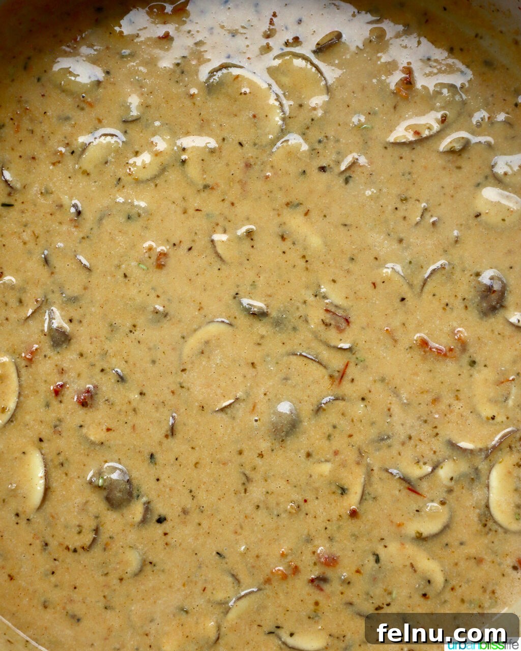 The Proposal Pasta 17 Cooked pasta being added to the creamy sauce in the large skillet.