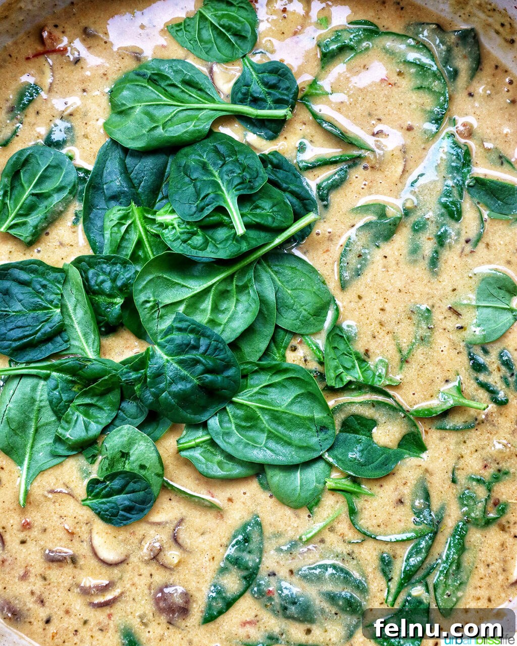 The Proposal Pasta 18 Pasta being tossed with the creamy Marry Me Pasta sauce in the pan, coating evenly.
