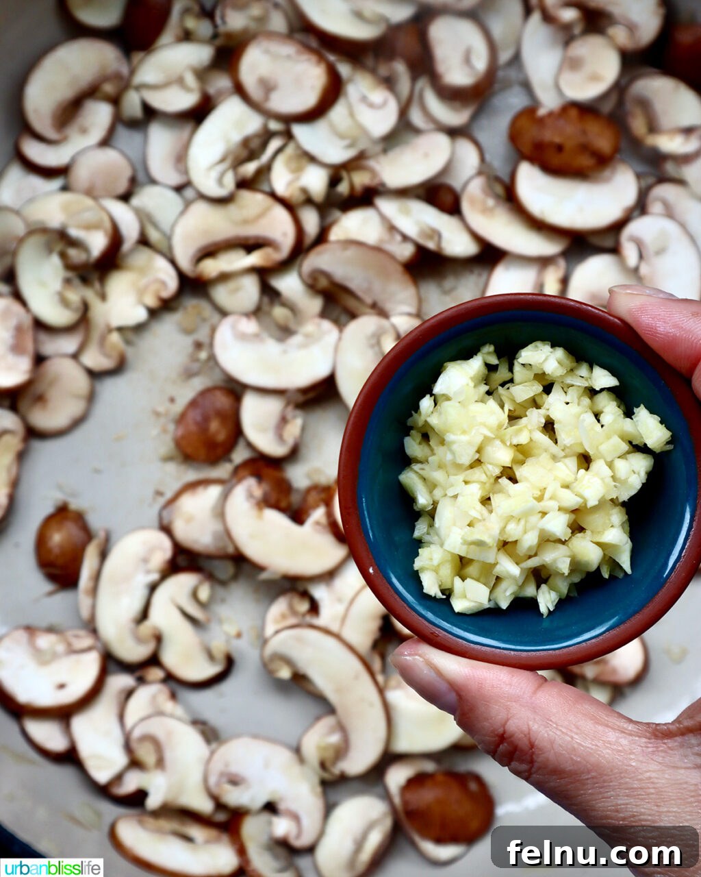 The Proposal Pasta 9 Seasonings and flour being added to sautéed mushrooms and aromatics in a pan.