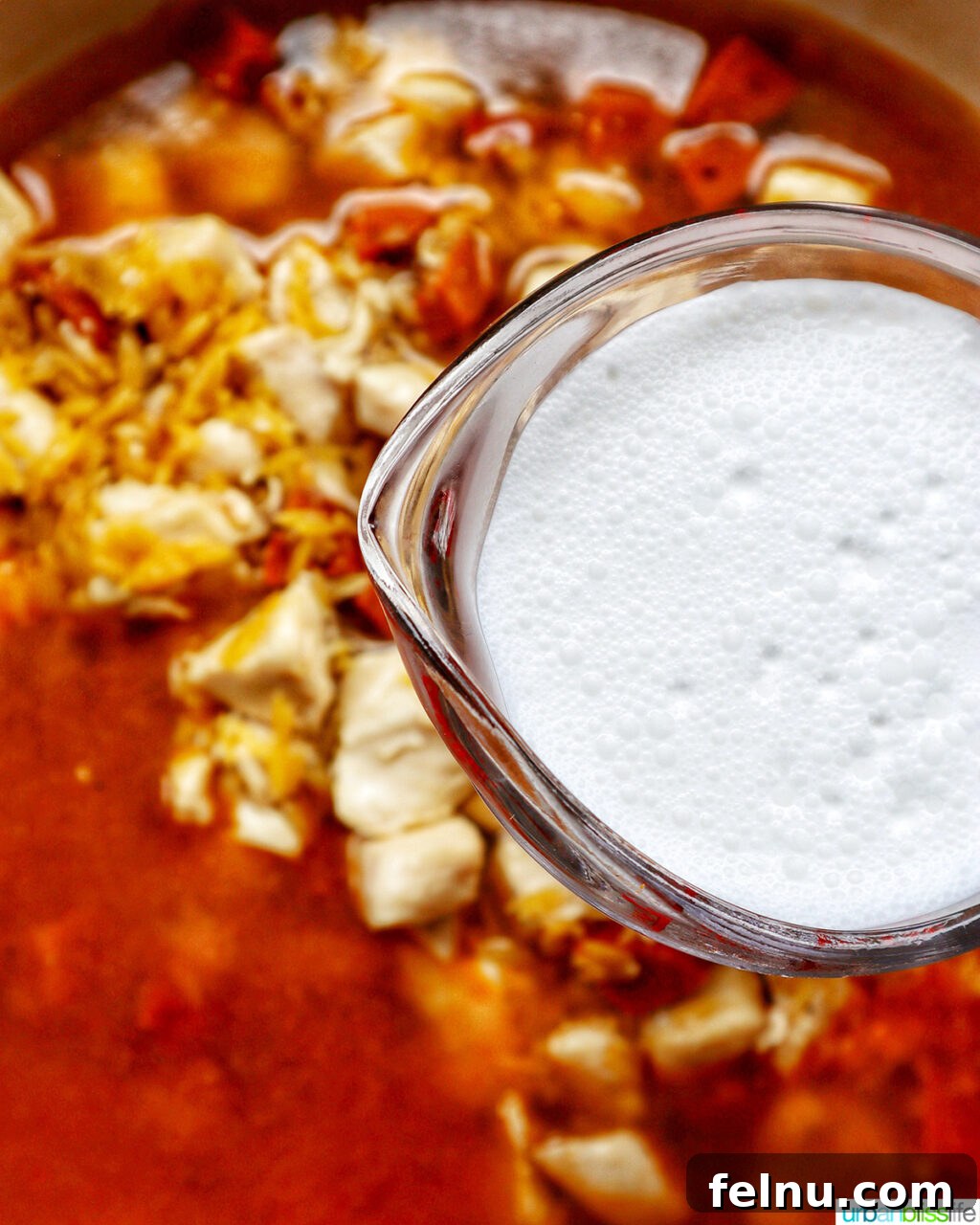 Chicken and Chorizo Orzo Skillet 13 adding cream to chorizo chicken cooking in a pan