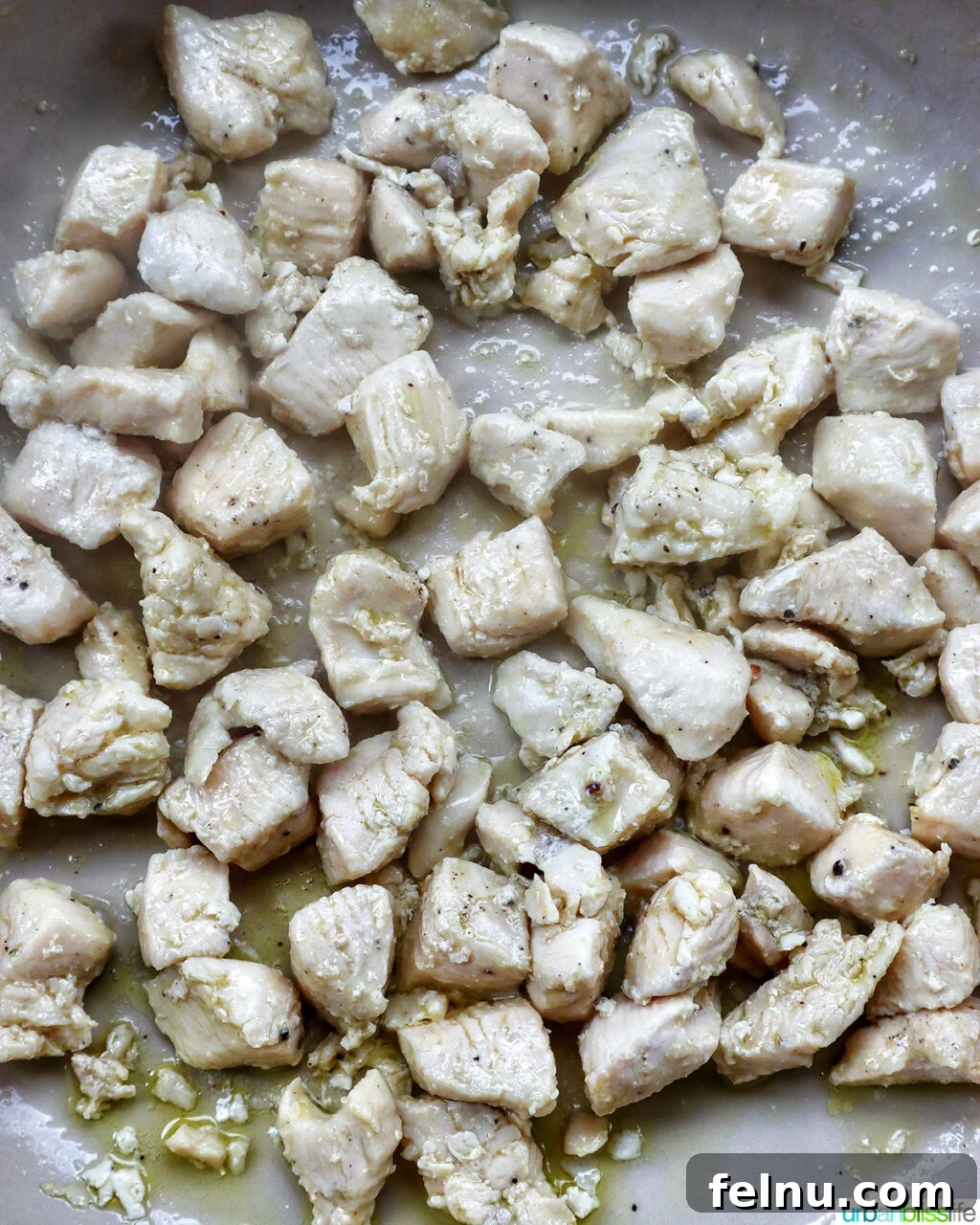 Chicken and Chorizo Orzo Skillet 7 cubed chicken cooking in a pan