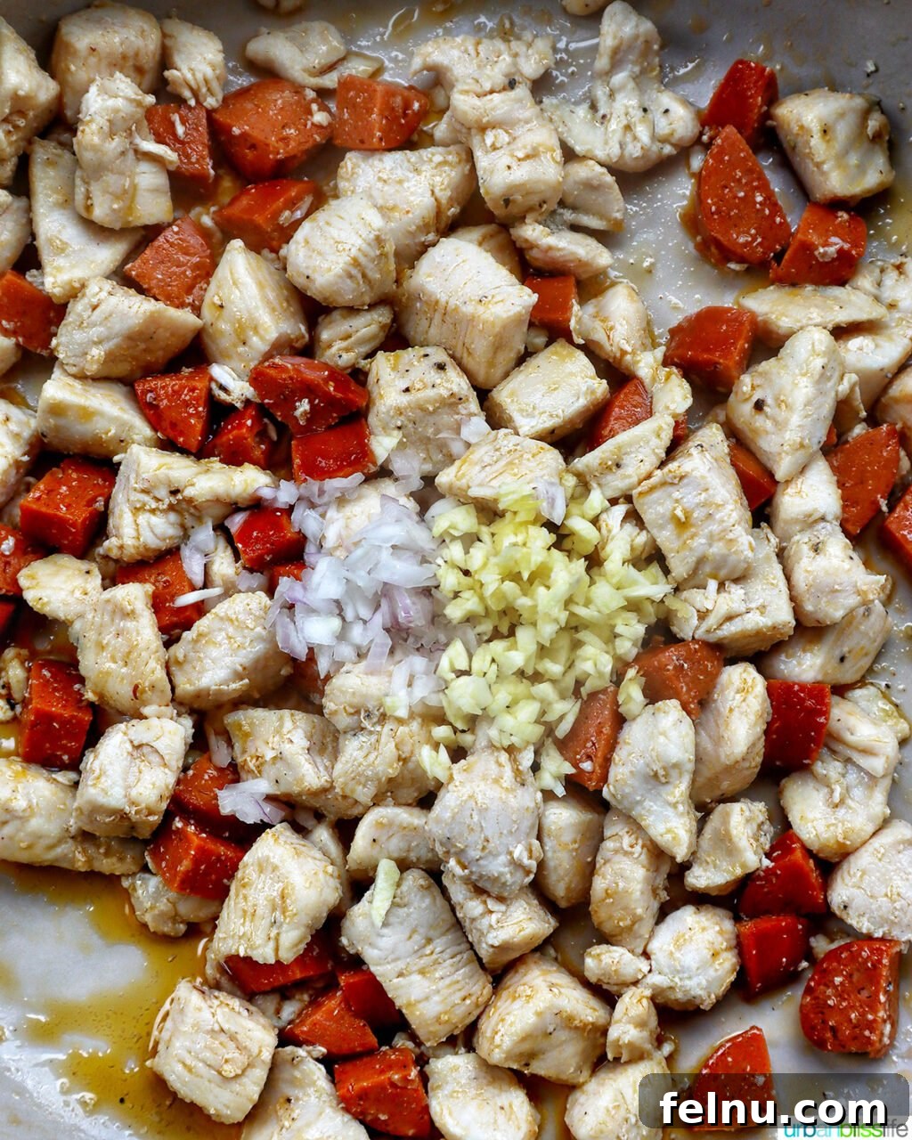 Chicken and Chorizo Orzo Skillet 9 garlic, onions, chorizo, chicken in a pan